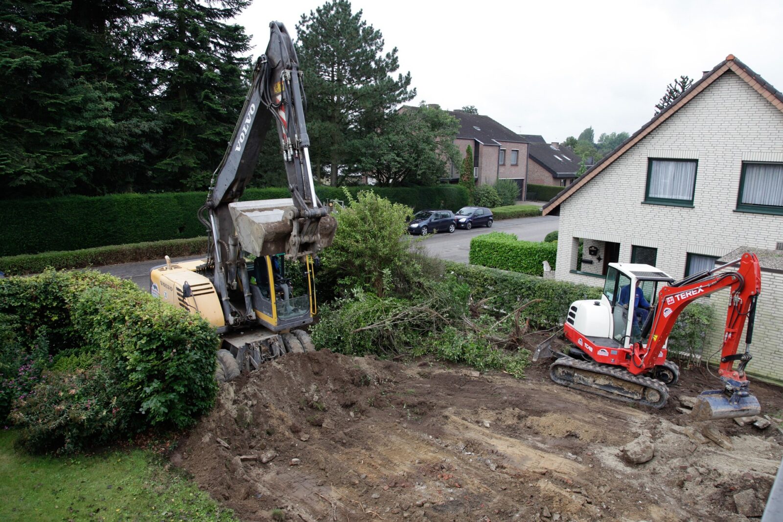 Drainage Solutions.. Digger scraping ground to insert drainage pipes
