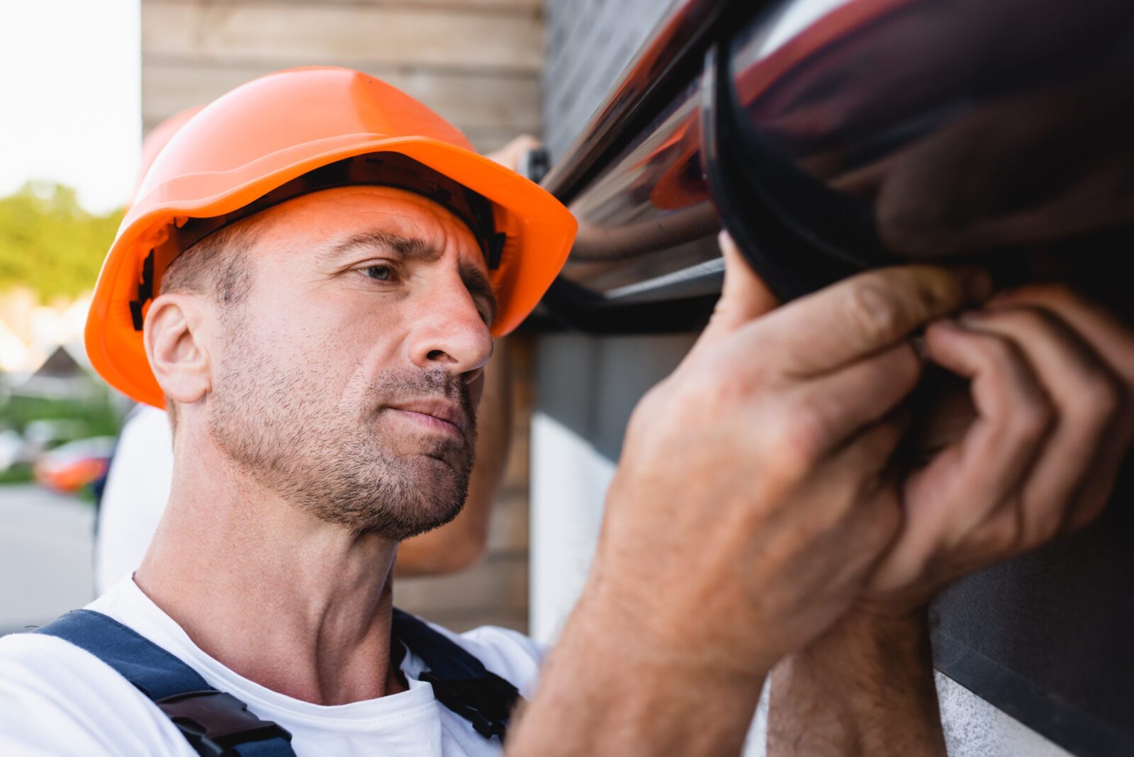 Connecting a Rain Gutter to the holding clip on a Roof UPVC Fascias as part Roof Maintenance