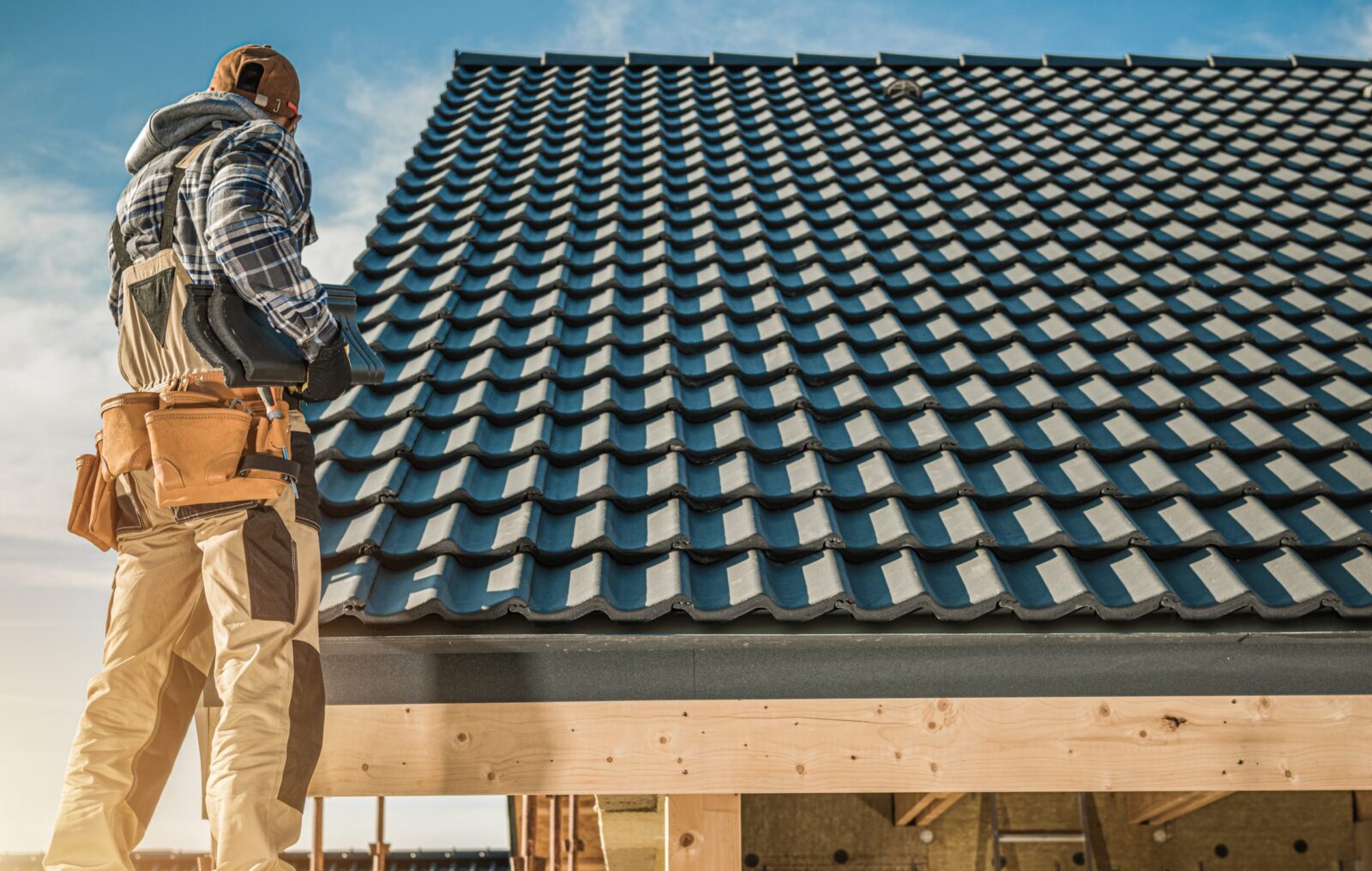 man standing next to Roof tiles, roof repair