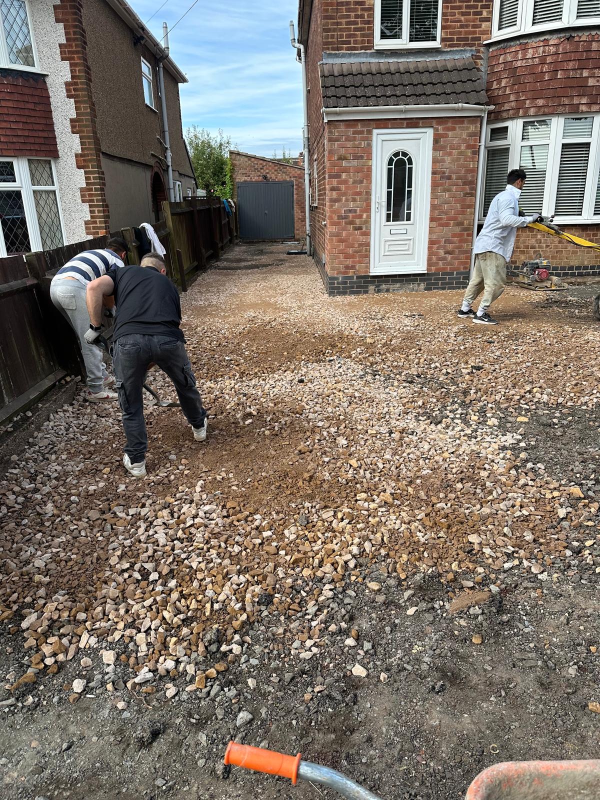 workers creating a gravel driveway due to realising the benefits of gravel driveways
