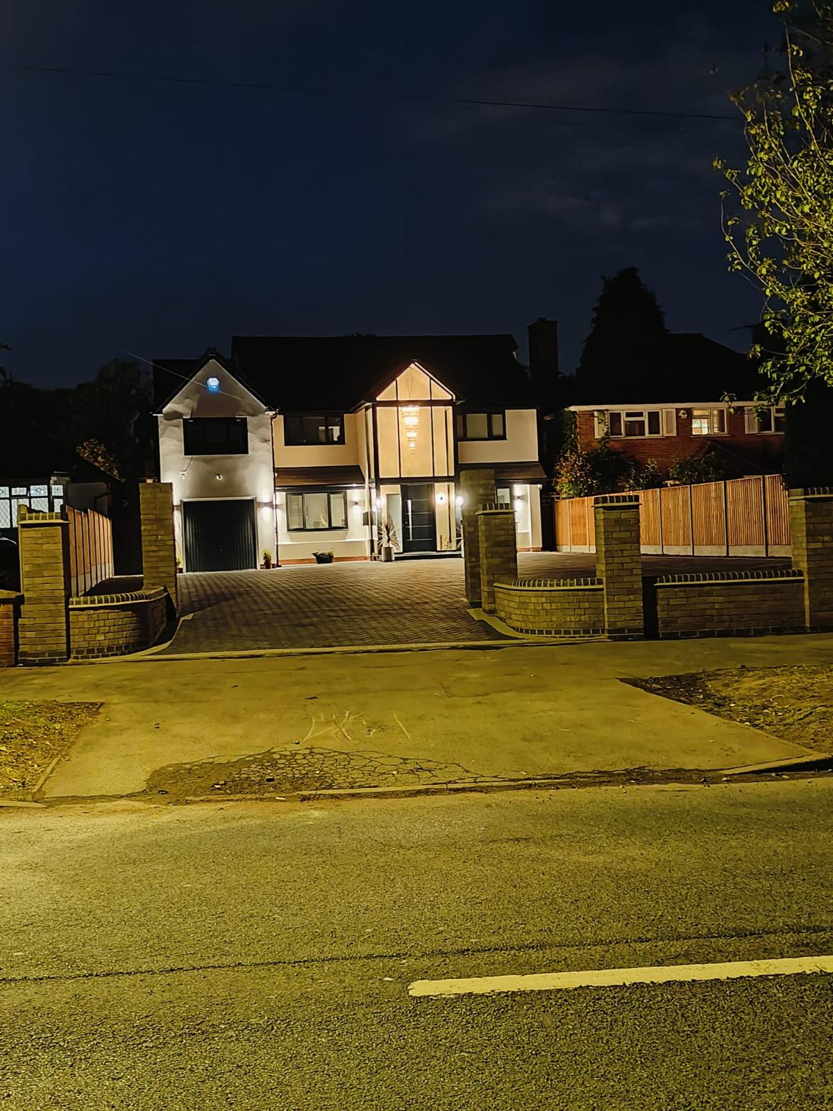 New Two story home at night preparing for Driveway Lighting