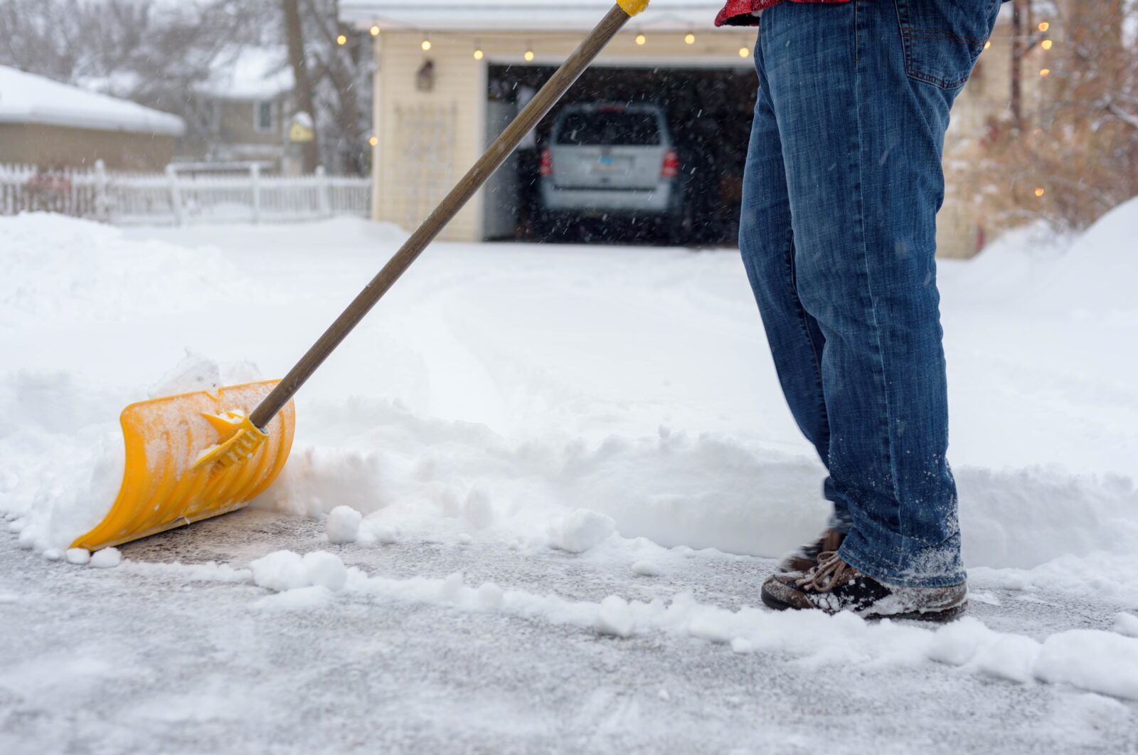Someone performing snowy driveway protection