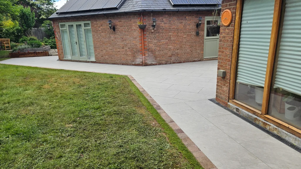 Premium Porcelain Patio with Brick Border and Professional Landscaping